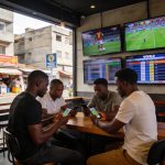 Create an editorial news illustration for an article about '1xBet World Win 2026 : le guide ultime pour les parieurs congolais pendant la Coupe du Monde'. The specific country is Republique du Congo (Brazzaville) (CG); make visual cues accurate to th