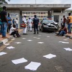 Create an editorial news illustration for an article about 'Accident mortel près du lycée Augustin Poignet : quatre vies fauchées en pleine session du BEPC'. The specific country is Republique du Congo (Brazzaville) (CG); make visual cues accurate to