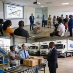 Create an editorial news illustration for an article about 'AGL Congo initie les étudiants aux métiers de la logistique lors d’une journée portes ouvertes'. The specific country is Republique du Congo (Brazzaville) (CG); make visual cues accurate to