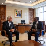 Create an editorial news illustration for an article about 'Congo : Claude Le Roy, nouveau sélectionneur des Diables Rouges, reçu par le Président Sassou-N’Guesso'. The specific country is Republique du Congo (Brazzaville) (CG); make visual cues accu