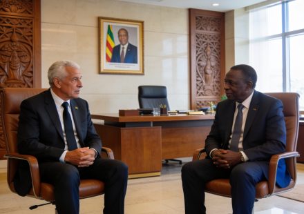 Create an editorial news illustration for an article about 'Congo : Claude Le Roy, nouveau sélectionneur des Diables Rouges, reçu par le Président Sassou-N’Guesso'. The specific country is Republique du Congo (Brazzaville) (CG); make visual cues accu