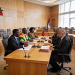 Create an editorial news illustration for an article about 'Congo – Maroc : la coopération parlementaire au cœur d’une rencontre au Sénat'. The specific country is Republique du Congo (Brazzaville) (CG); make visual cues accurate to this exact countr