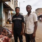 Create an editorial news illustration for an article about "Deux braconniers présumés arrêtés avec de la viande d'hippopotame à Brazzaville". The specific country is Republique du Congo (Brazzaville) (CG); make visual cues accurate to this exact coun