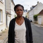 Create an editorial news illustration for an article about 'Féminicide à Blois : une Congolaise de 40 ans poignardée par son mari'. The specific country is Republique du Congo (Brazzaville) (CG); make visual cues accurate to this exact country and av