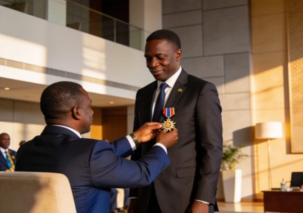 Create an editorial news illustration for an article about 'Norbert Okiokoutina fait Grand commandeur de l’ordre du mérite de la Cémac'. The specific country is Republique du Congo (Brazzaville) (CG); make visual cues accurate to this exact country a