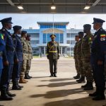 Create an editorial news illustration for an article about 'Pointe-Noire : intronisation du nouveau commandant de la Zone militaire de défense no 1'. The specific country is Republique du Congo (Brazzaville) (CG); make visual cues accurate to this ex