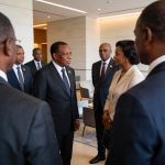 Create an editorial news illustration for an article about 'Sassou Nguesso à Libreville pour le mariage de Junior Bongo : une union sous le signe de la diplomatie'. The specific country is Republiqe du Congo (CG); make visual cues accurate to this ex